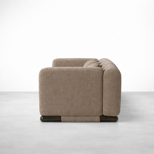 Beige linen sofa with teakwood base by Interiorze side view showing rounded arms and low base