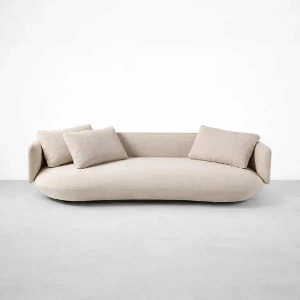 Ivory curved sofa front view with loose cushions by INTERIORZE Title: Ivory Curved Sofa Front View