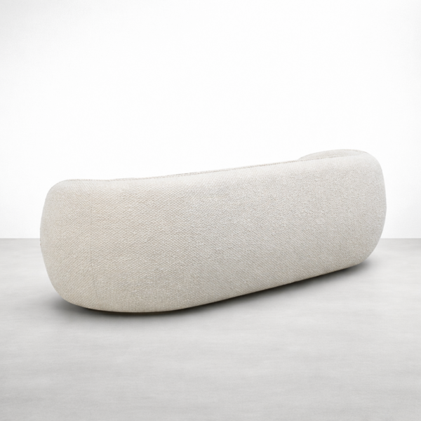 Close-up of cream boucle sofa fabric texture on curved sofa by INTERIORZE