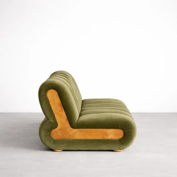 Side view of teakwood green sofa showing rounded profile and teak wood accent panel