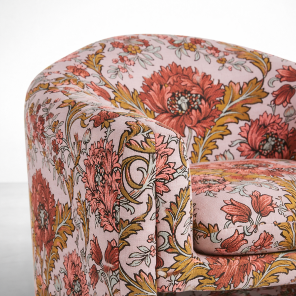 Floral swivel chair close-up showing print detail and upholstered arm