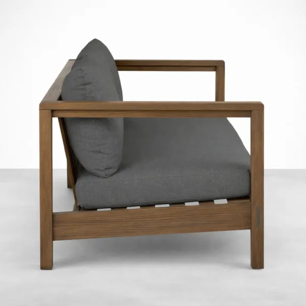 Teakwood outdoor sofa with charcoal grey cushions and open arm frame by INTERIORZE