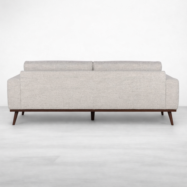 Back view of beige fabric sofa with teakwood base by INTERIORZE
