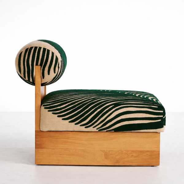 Side view of teakwood base lounge chair with green zebra print upholstery