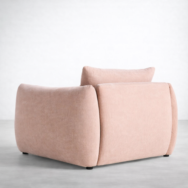 Back view of blush pink lounge chair with rounded corners