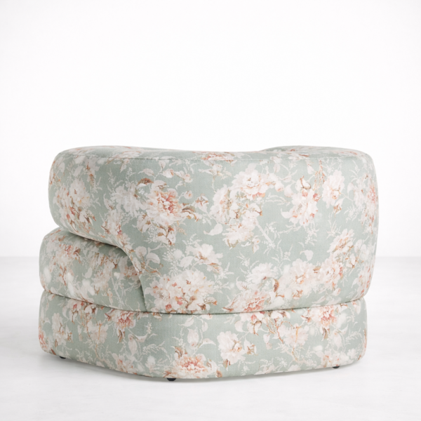 Back view of round floral accent chair with all-over sage green floral upholstery