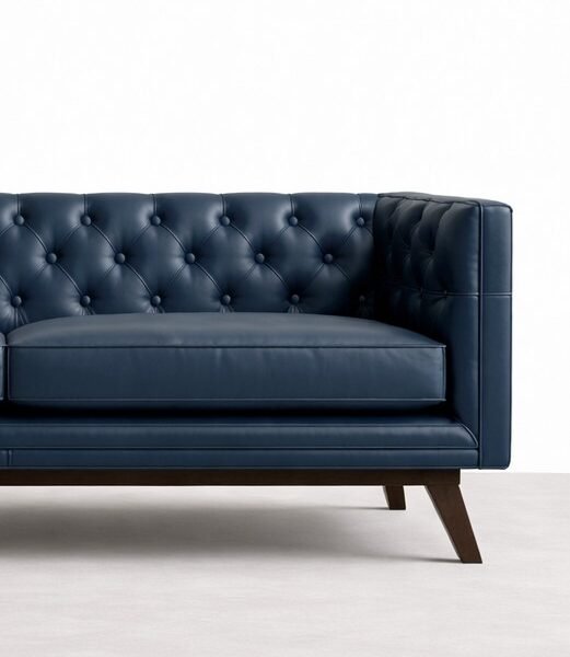 Close-up of diamond tufting on navy blue leather sofa by Interiorze