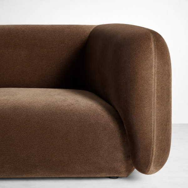 Close-up of brown velvet upholstery on curved sofa by Interiorze