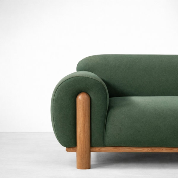 Angled view of forest green sofa with ash wood frame by INTERIORZE