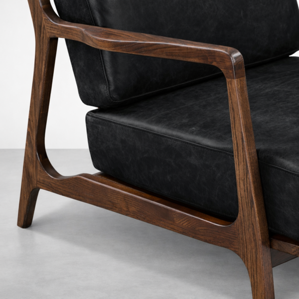 black leather armchair teakwood frame detail close up