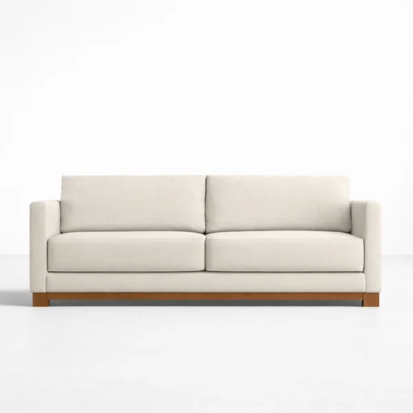 Front view of ivory fabric sofa with teakwood frame and teakwood base by INTERIORZE