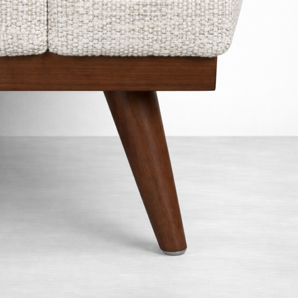 Teakwood base and leg detail of beige fabric sofa by INTERIORZE