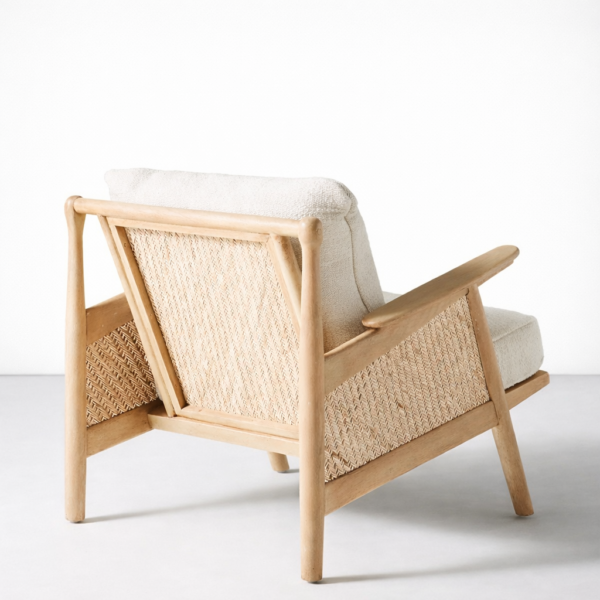 Back view of ash wood cane lounge chair with woven cane panel and cream cushion