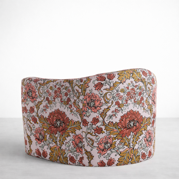 Floral swivel chair back view with blush garden print upholstery