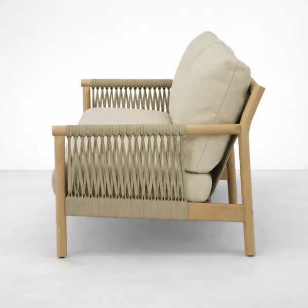 Side view of teakwood rope sofa showing woven rope arm and beige cushion profile