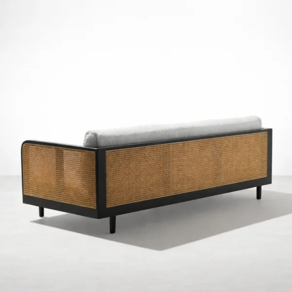 Back angled view of INTERIORZE Vihaan teak wood cane 3 seater sofa with black frame and woven cane back