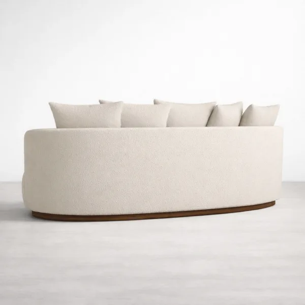 Back view of ivory boucle sofa with smooth form and teakwood base by INTERIORZE