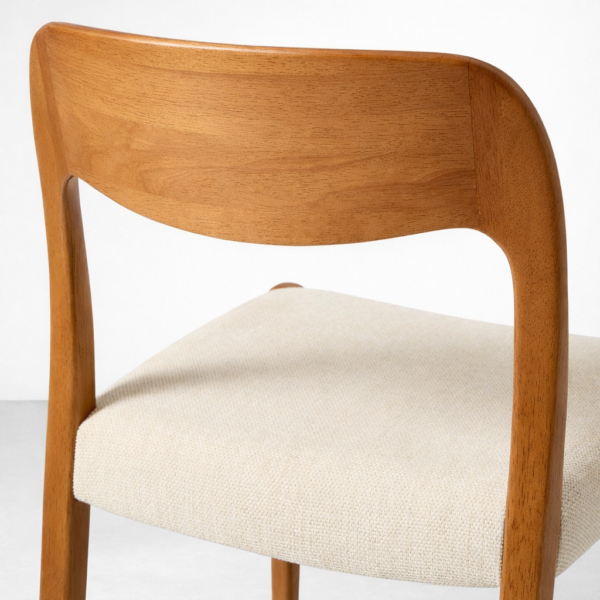 Close up of teakwood backrest and upholstered seat dining chair