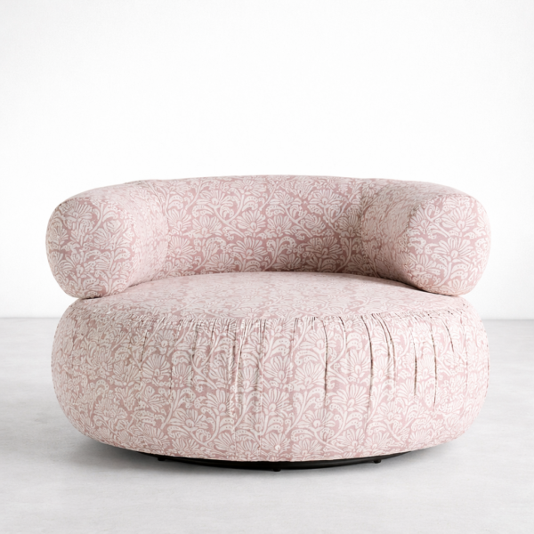 Blush pink floral swivel chair front view with rounded wraparound back
