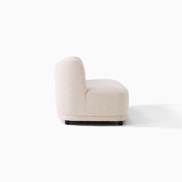 Side view of ivory boucle armless sofa with curved back INTERIORZE Lune