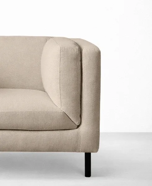 Beige accent chair close-up showing inner cushion and arm detail, INTERIORZE DUNE.