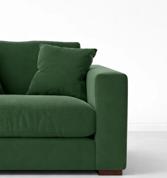 Green velvet lounge chair close-up showing cushion and teakwood leg detail, INTERIORZE EVERGREEN.
