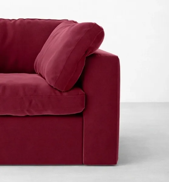 Burgundy velvet lounge chair with teakwood legs close-up showing arm and cushion, INTERIORZE RUBYLOFT.