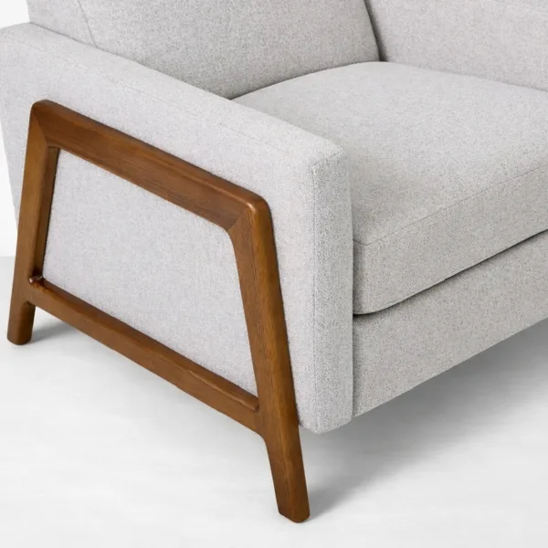 Close-up of teakwood arm frame detail on ash grey recliner chair