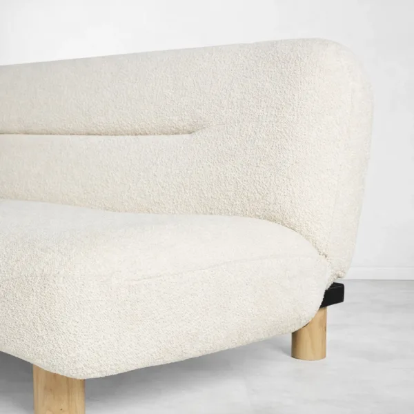 Ivory boucle fabric texture close-up with teakwood leg detail on INTERIORZE sofa