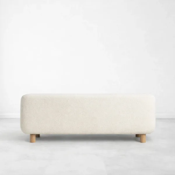 Ivory boucle sofa back view showing clean curved back and teakwood legs