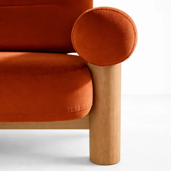 Rust orange 2 seater sofa with teakwood leg and rounded bolster arm detail by INTERIORZE Terra