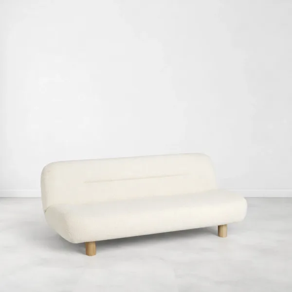 Ivory boucle sofa angled view showing rounded form and modern low profile