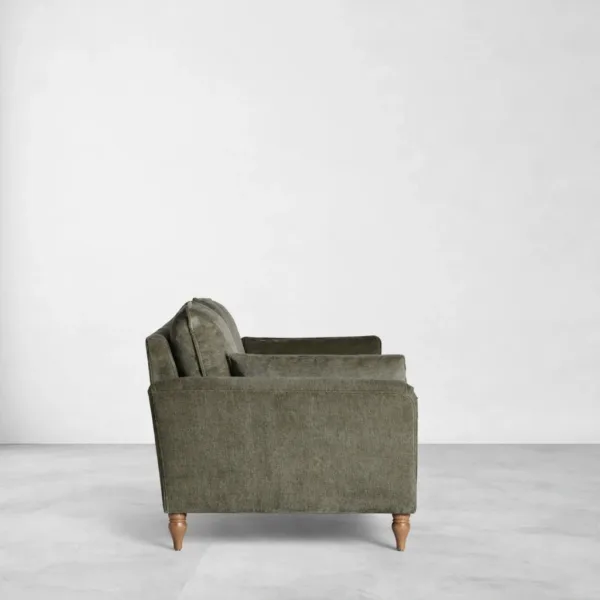 Olive green 2 seater sofa side view with rounded armrest and supportive cushions