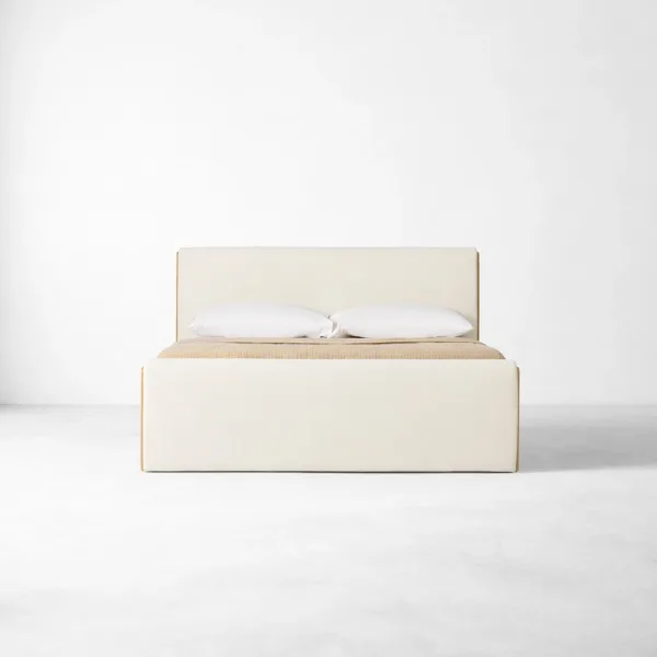 Upholstered teakwood bed front view with upholstered footboard in ivory fabric