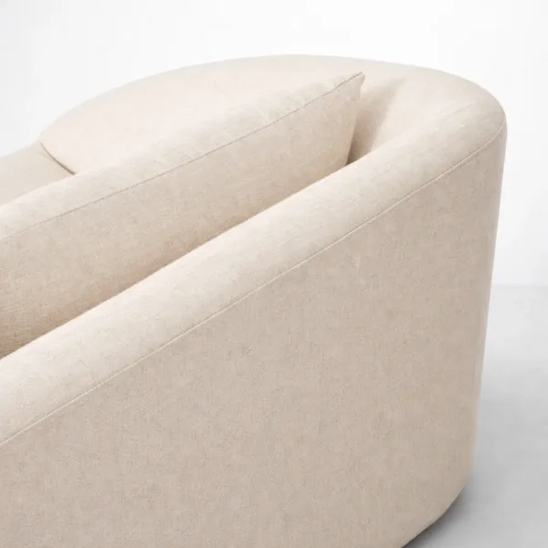 Curved ivory linen sectional sofa close-up showing rounded back by INTERIORZE