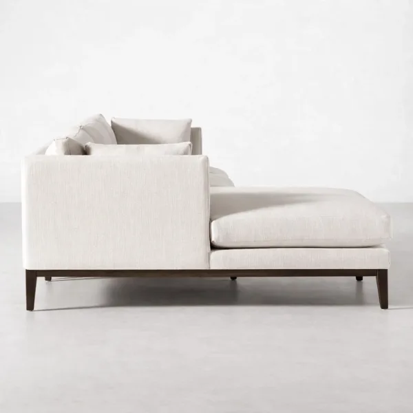 Side view of ivory chaise sectional sofa with teakwood base and deep seat