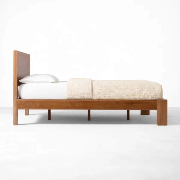 Solid teakwood bed side view showing sturdy frame and under-bed clearance by INTERIORZE