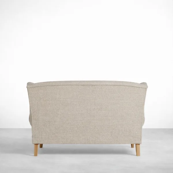 Beige wingback sofa back view showing tall backrest and clean upholstery finish