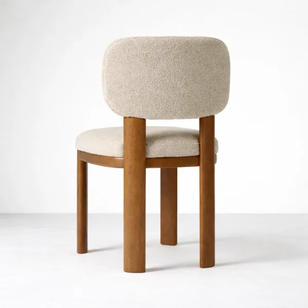 Back view of ivory bouclé dining chair with teak wood legs