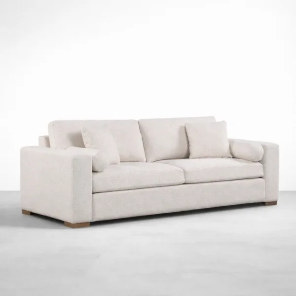 Beige 2 seater sofa angled front view showing modern profile and pillows by INTERIORZE