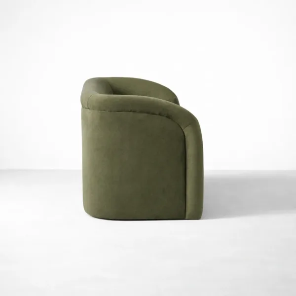 Side view of INTERIORZE Olive Arc olive green velvet 2 seater sofa showing curved arm, low back, and smooth upholstery lines
