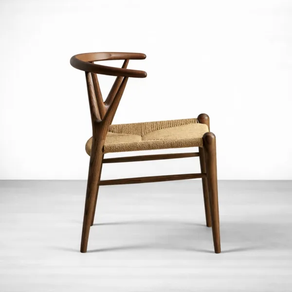 Teak wishbone dining chair side profile showing curved back and rope seat