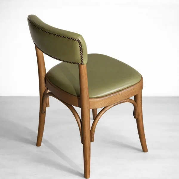 Close-up of olive green upholstery and trim detail on dining chair
