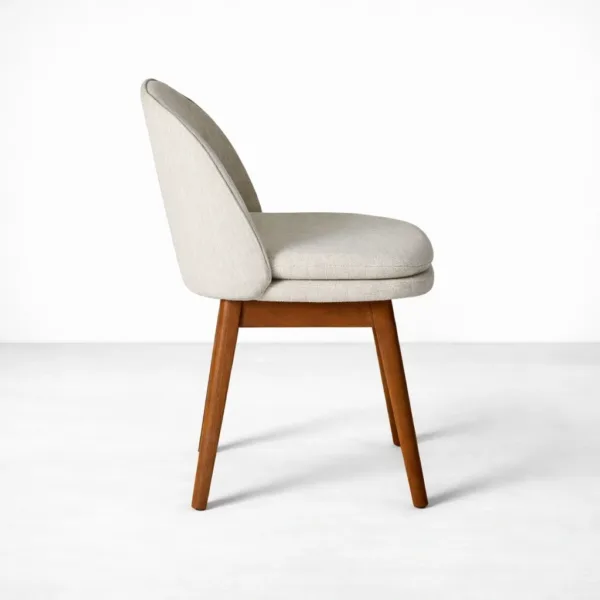 Upholstered teakwood dining chair side view ivory fabric and walnut polish legs