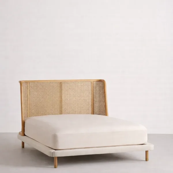 Teakwood cane bed with upholstered base and cane headboard angled view