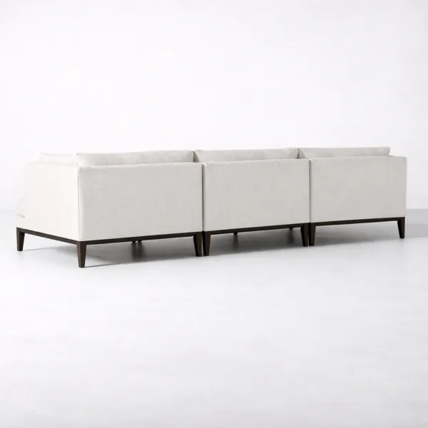 Back view of ivory sectional sofa showing clean panels and teakwood legs