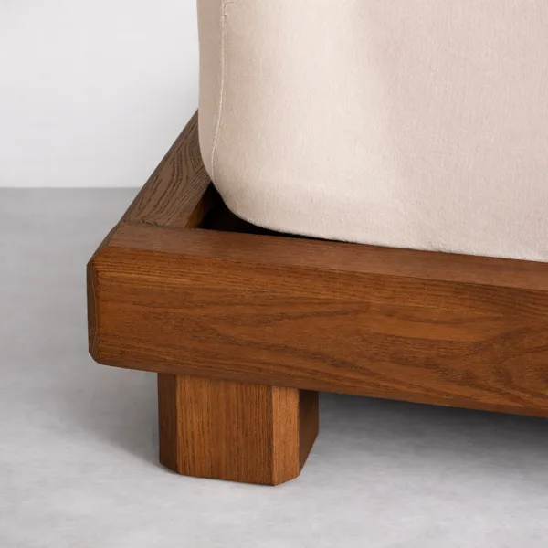 Teakwood upholstered bed platform corner and leg detail in walnut teak finish