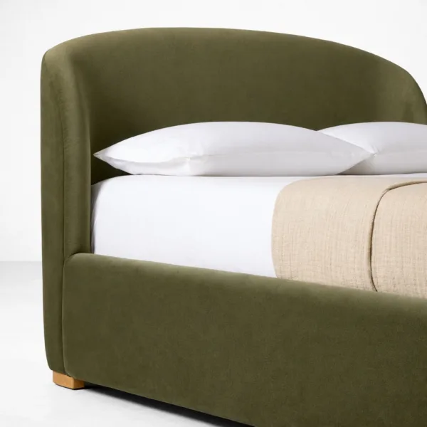Close-up of olive green velvet upholstered headboard on INTERIORZE bed