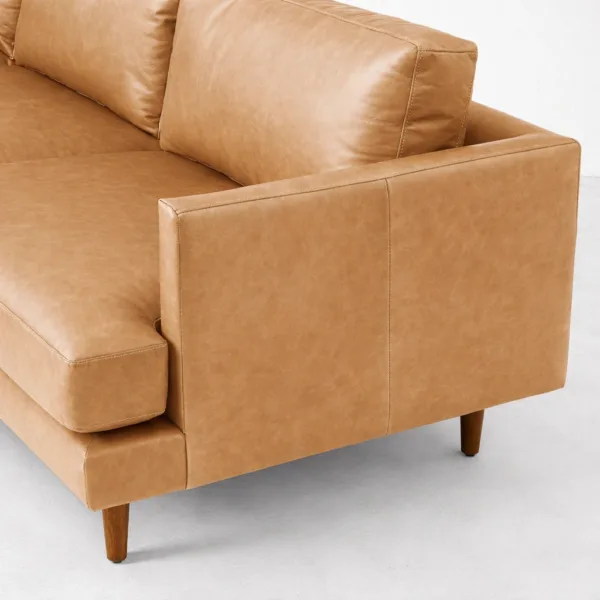 Tan leather L shaped sectional sofa close up showing arm and backrest by INTERIORZE