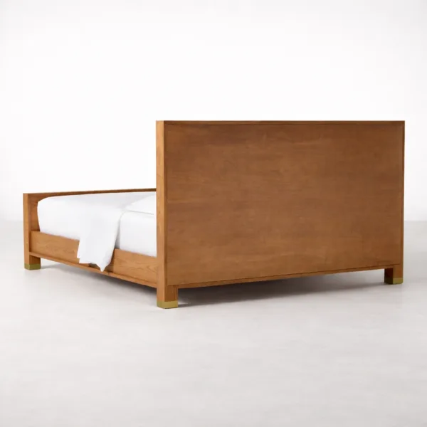 Rear angled view of INTERIORZE Elora teakwood upholstered panel bed in warm teak polish